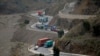 Trucks carry goods on its way to neighboring Afghanistan through the Khyber Pass in Pakistani tribal area, March 21, 2017. A Pakistani border official says hundreds of trucks have crossed into Afghanistan from Pakistan after the border reopened for the fi