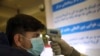 An Afghan health worker takes the temperature of a passenger as a preventive measure for Coronavirus, during screening of travelers who arrived from China, at the Hamid Karzai International Airport in Kabul, Afghanistan, Monday, Feb. 3, 2020…