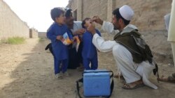 A boy receives polio vaccine during a house to house visit in Khost, Afghanistan, March 2021.