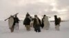 In this picture released exclusively to Reuters Jan. 17, 2009, Taliban militants are seen with their weapons in an undisclosed location in Afghanistan. With recents attacks, the group has been defying a longstanding practice of 'winter lull,' 'spring offe