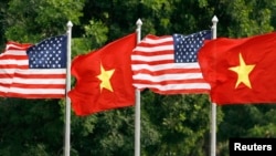 FILE U.S. and Vietnamese flags flutter in the wind at the presidential palace in Hanoi where U.S. President George W. Bush is visiting November 17, 2006. 